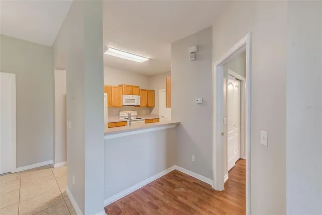 a view of hallway with wooden floor