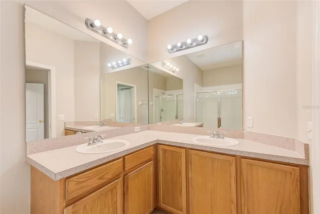 a bathroom with a sink double vanity and a mirror