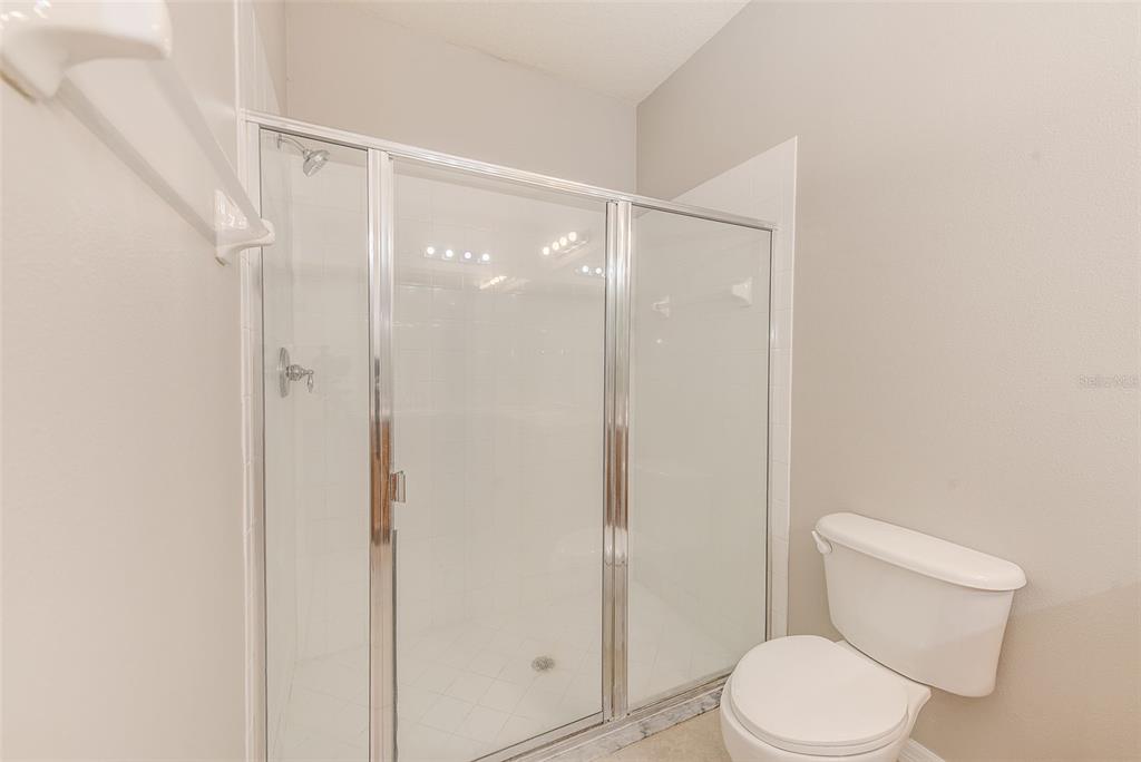 20306 Oak Key Court Tampa, FL 33647 - Photo 24 of 46 a white toilet sitting next to a shower