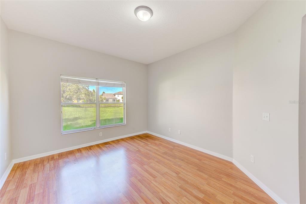 20306 Oak Key Court Tampa, FL 33647 - Photo 25 of 46 an empty room with wooden floor and windows