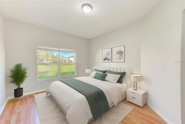 a bedroom with a large bed and a large window