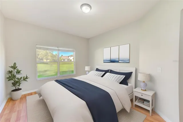 a bedroom with a bed and a large window