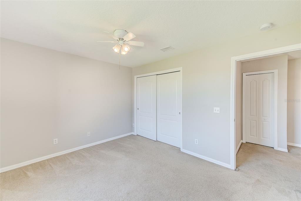 20306 Oak Key Court Tampa, FL 33647 - Photo 31 of 46 an empty room with a chandelier fan