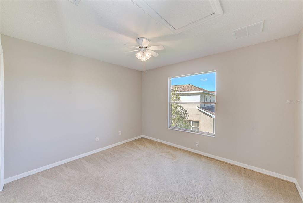 20306 Oak Key Court Tampa, FL 33647 - Photo 34 of 46 an empty room with a window and ceiling fan