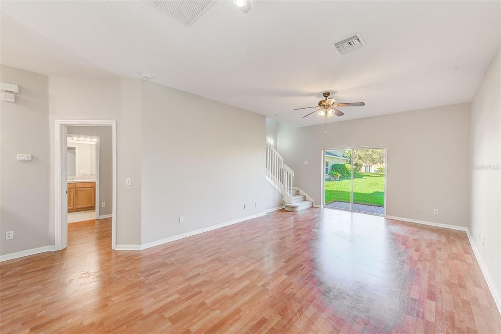 20306 Oak Key Court Tampa, FL 33647 - Photo 9 of 46 a view of an empty room with a window and wooden floor
