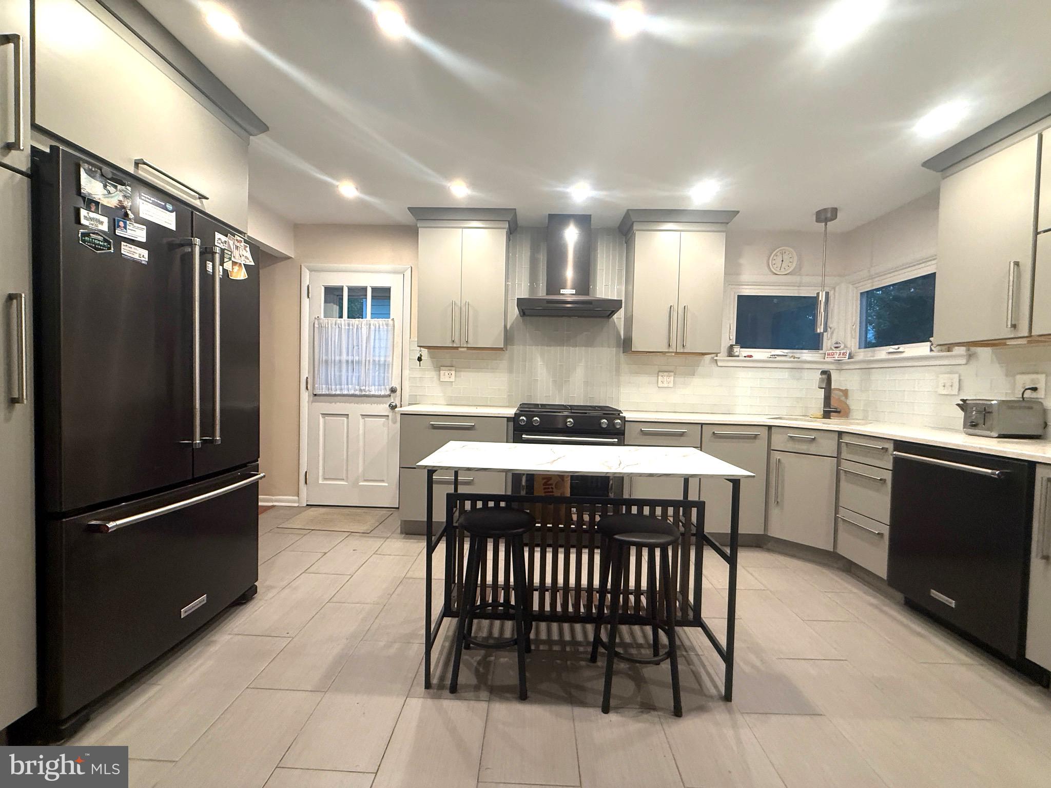 450 Foster Drive Springfield, PA 19064 - Photo 6 of 16 a kitchen with a refrigerator a sink and cabinets