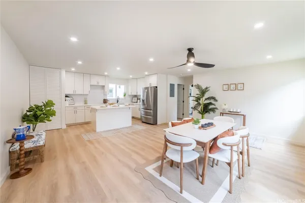 a dining room with furniture and a kitchen view
