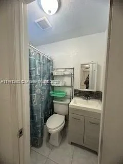 a bathroom with a toilet a sink and a shower