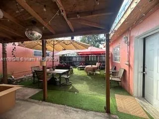 a kitchen with a refrigerator a stove a sink dishwasher with a dining table and chairs