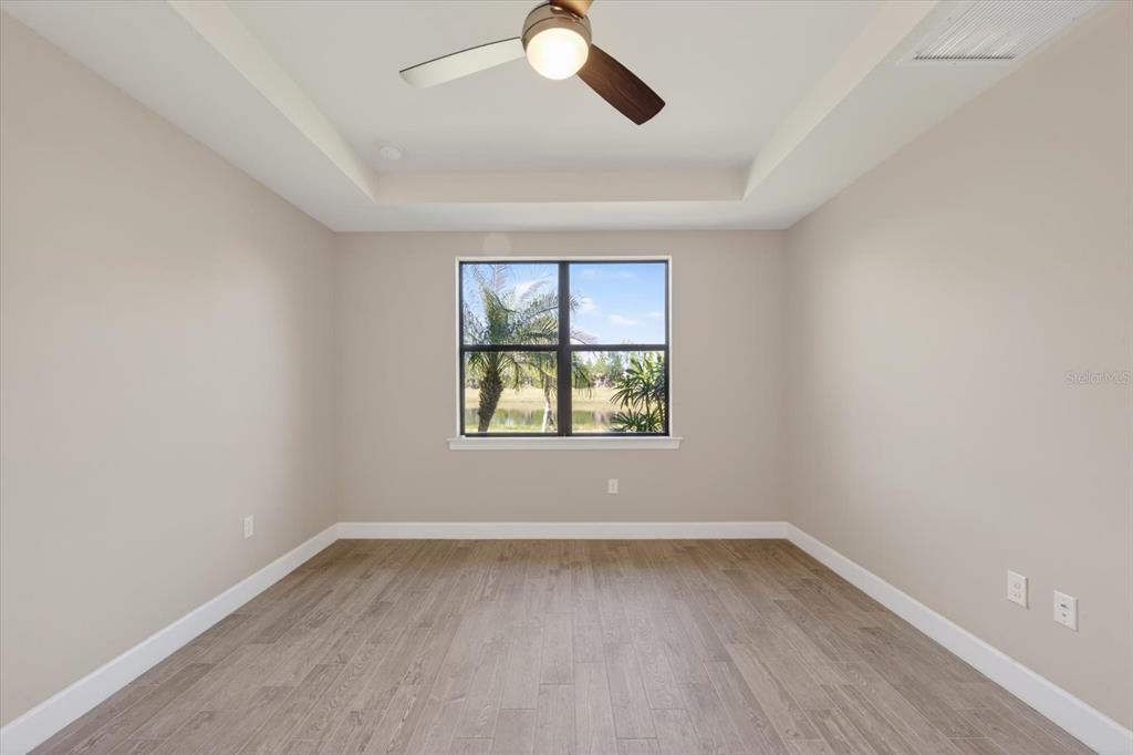 6745 Chester Trail Bradenton, FL 34202 - Photo 13 of 95 an empty room with wooden floor and windows