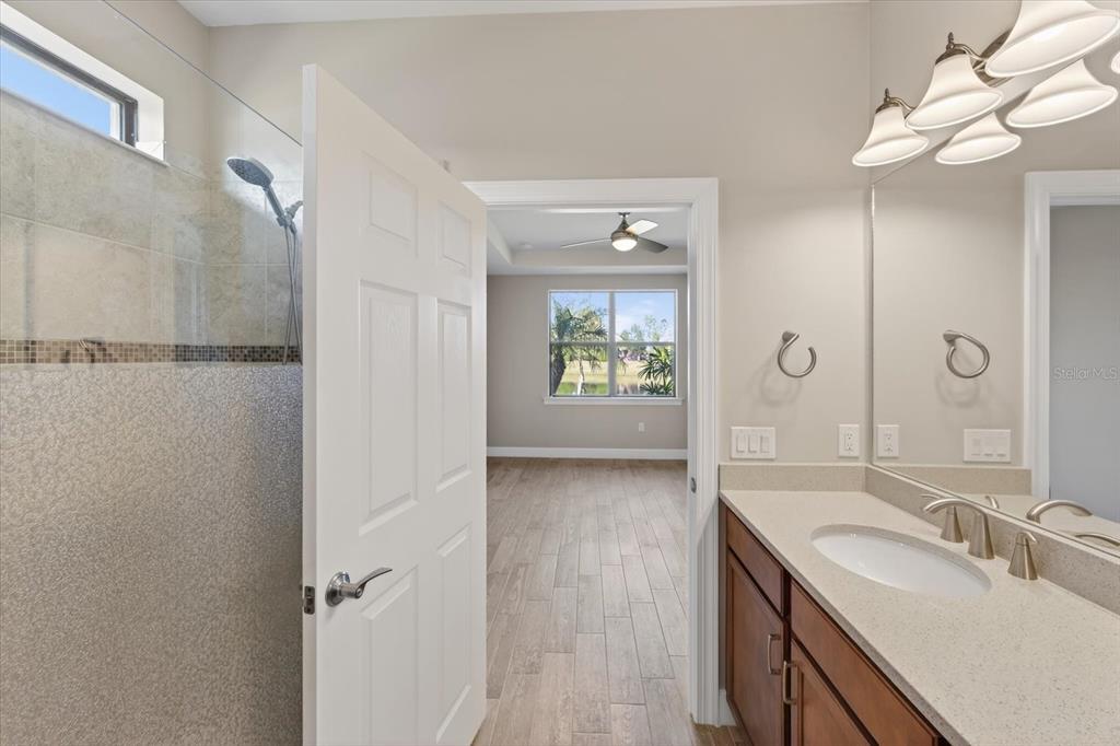 6745 Chester Trail Bradenton, FL 34202 - Photo 18 of 95 a bathroom with a sink a mirror and a shower
