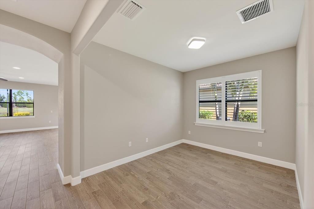 6745 Chester Trail Bradenton, FL 34202 - Photo 21 of 95 an empty room with wooden floor and windows