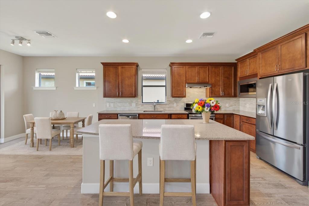 6745 Chester Trail Bradenton, FL 34202 - Photo 33 of 95 a kitchen with stainless steel appliances a table and chairs
