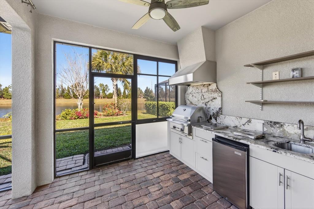 6745 Chester Trail Bradenton, FL 34202 - Photo 41 of 95 a kitchen with stainless steel appliances granite countertop a stove and a large window