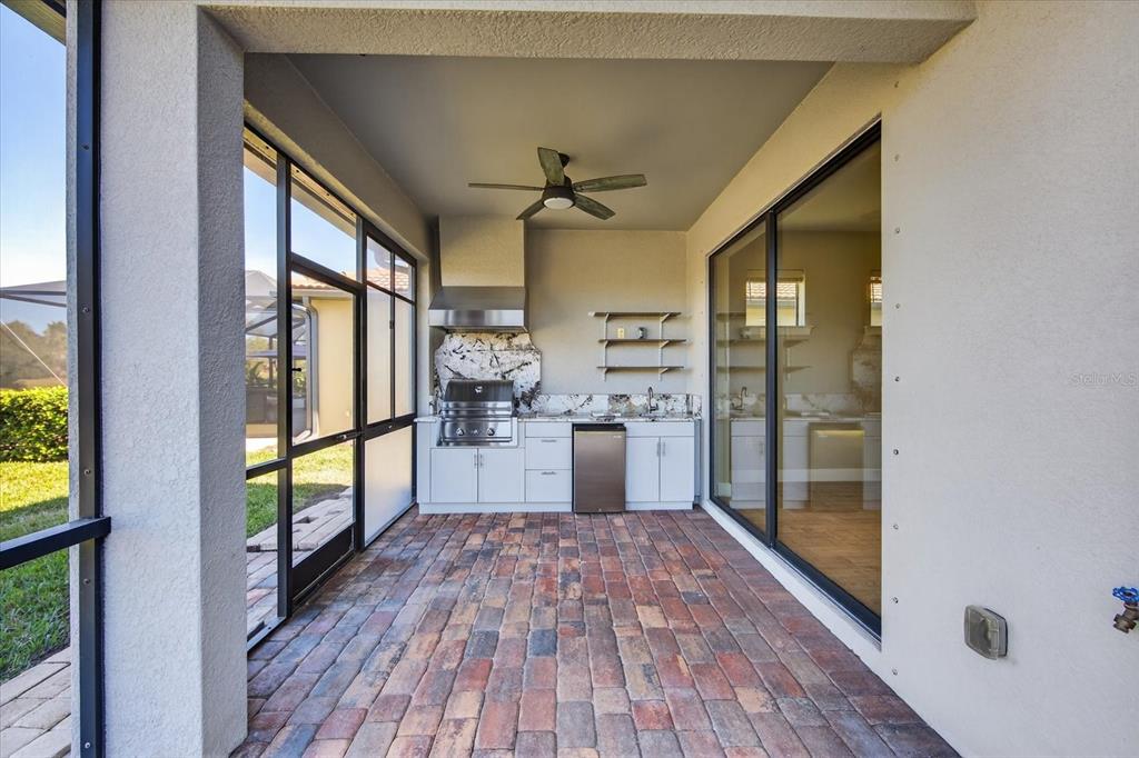 6745 Chester Trail Bradenton, FL 34202 - Photo 43 of 95 a kitchen with stainless steel appliances granite countertop a refrigerator and a wooden floor