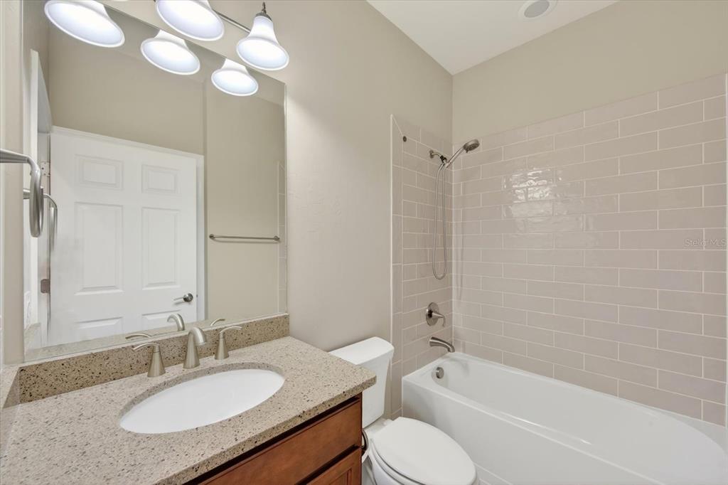6745 Chester Trail Bradenton, FL 34202 - Photo 9 of 95 a bathroom with a granite countertop sink mirror toilet and bathtub