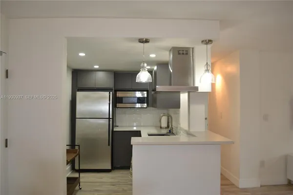 a kitchen with stainless steel appliances a refrigerator and a sink