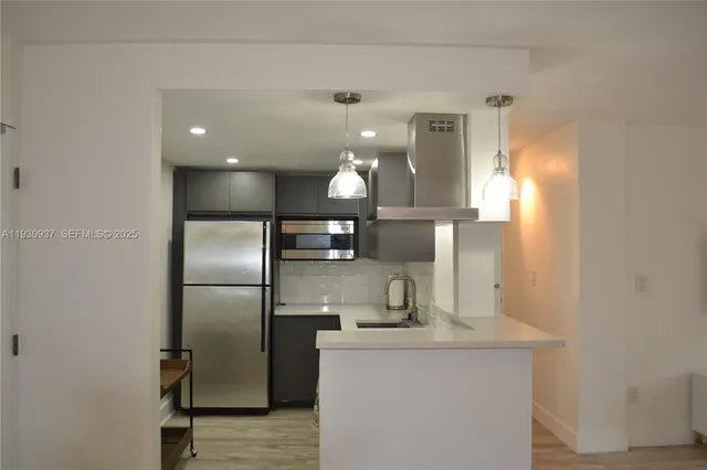 a kitchen with stainless steel appliances a refrigerator and a sink