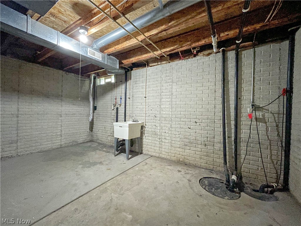 263 Reed Avenue Campbell, OH 44405 - Photo 29 of 30 Basement with brick wall and sink