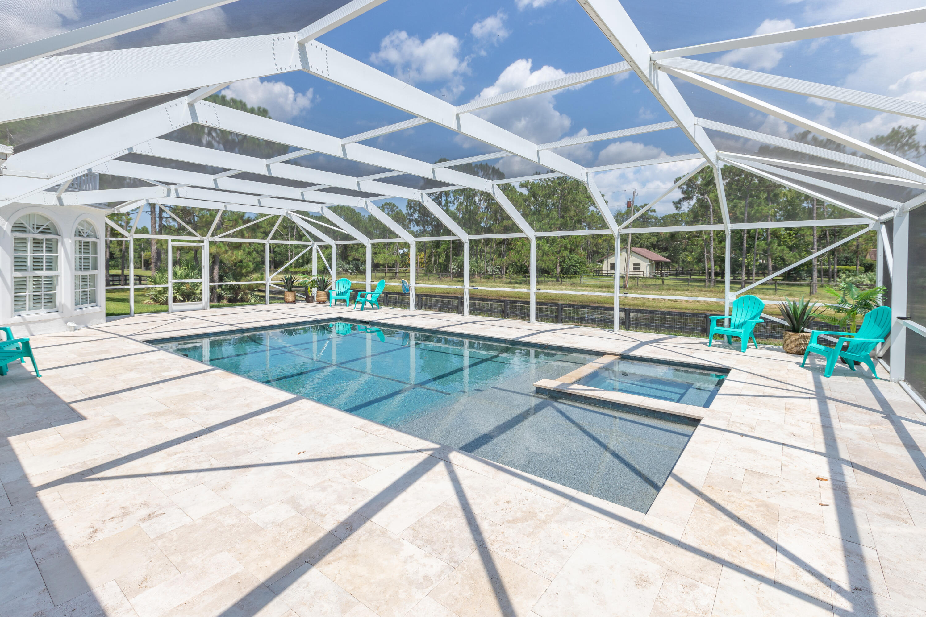 13230 Running Water Road Palm Beach Gardens, FL 33418 - Photo 15 of 32 a view of a swimming pool with a lounge chairs