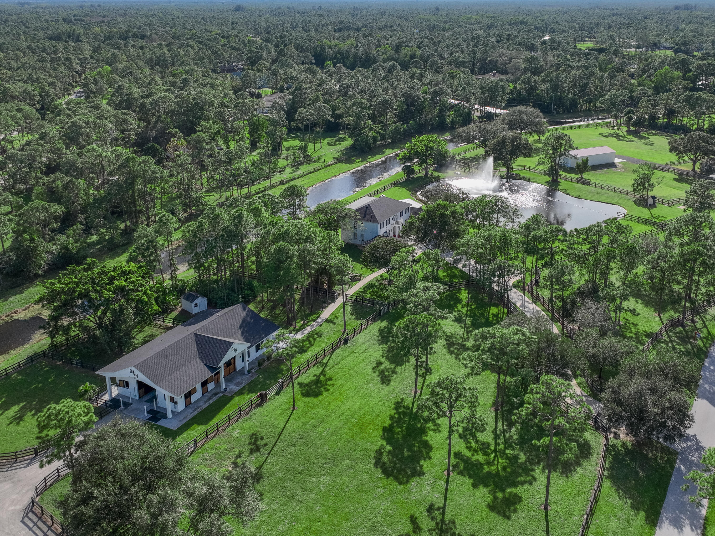 13230 Running Water Road Palm Beach Gardens, FL 33418 - Photo 2 of 32 an aerial view of residential house with outdoor space and trees all around