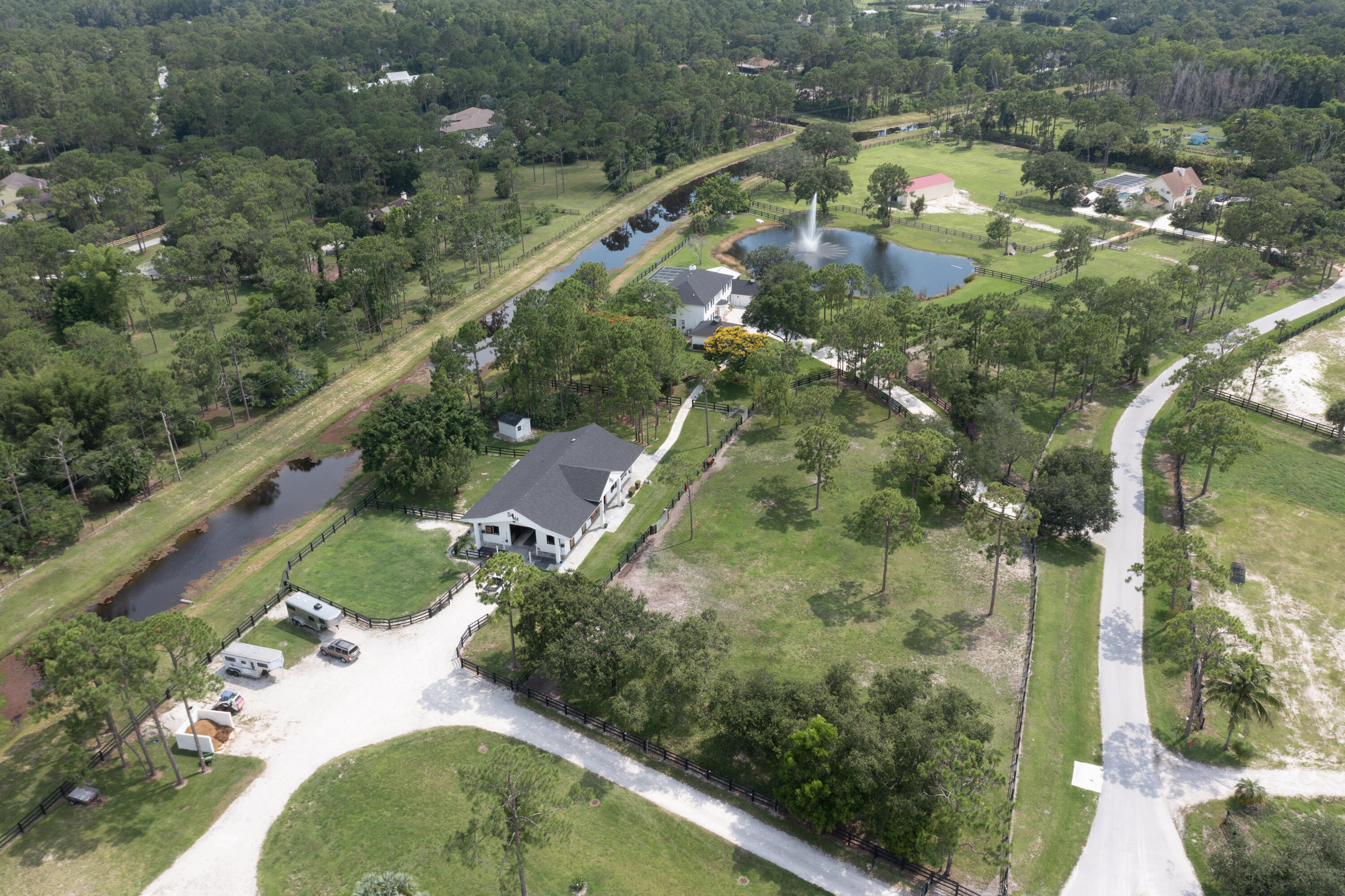 13230 Running Water Road Palm Beach Gardens, FL 33418 - Photo 28 of 32 an aerial view of a residential houses with outdoor space and street view