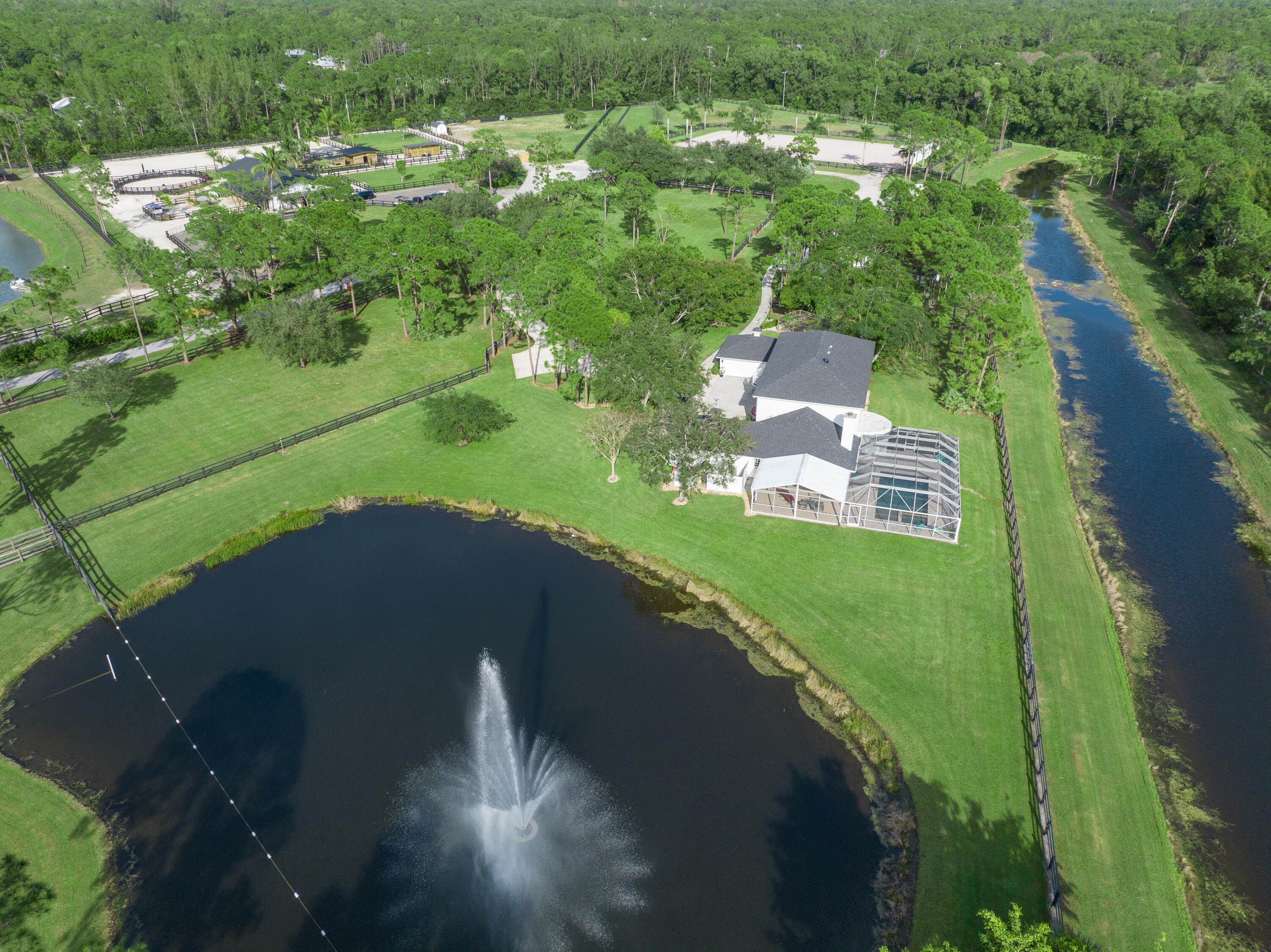 13230 Running Water Road Palm Beach Gardens, FL 33418 - Photo 31 of 32 an aerial view of a house with a yard and lake view