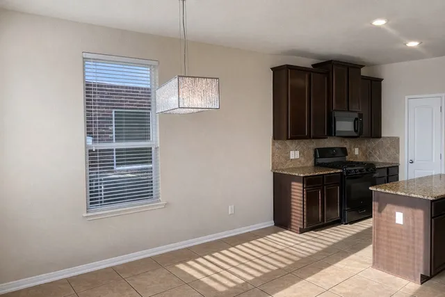 a view of a small space with wooden floor and a window