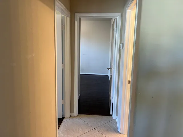 a wooden bench sitting next to a window