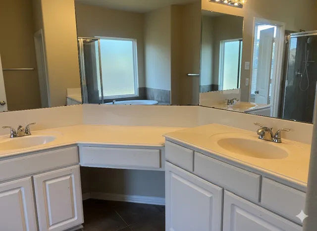 a bathroom with a granite countertop toilet a sink and bathtub