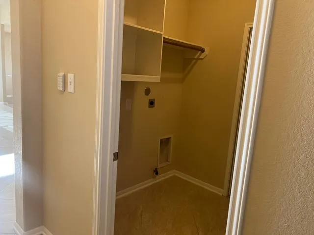 a view of hallway with a large window and doors