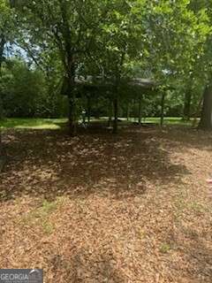 1803 Rocky Creek Road Macon, GA 31206 - Photo 3 of 10 a backyard of a house with lots of green space