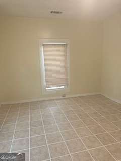 1803 Rocky Creek Road Macon, GA 31206 - Photo 7 of 10 a view of an empty room with a empty space and a window