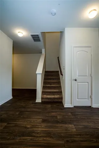 a view of entryway and hall with wooden floor