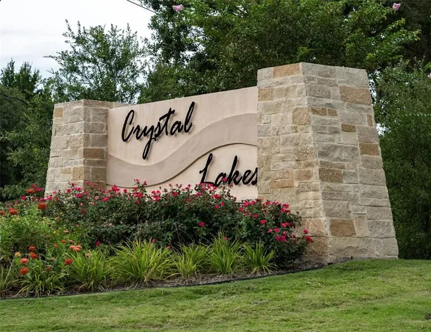 a sign that is in front of flowers