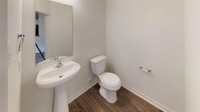 a bathroom with a sink toilet and a mirror