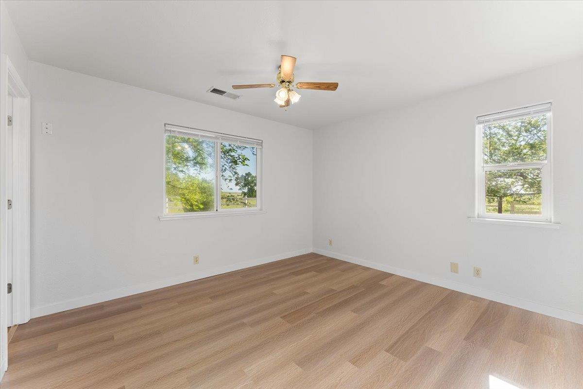 18476 Paskenta Road Corning, CA 96021 - Photo 19 of 57 wooden floor in an empty room with a window