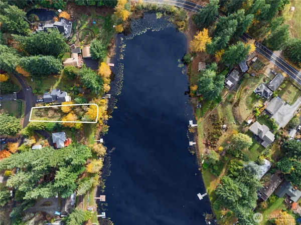 an aerial view of a house with a yard and garden