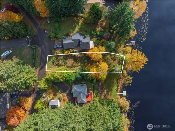 an aerial view of a house with swimming pool outdoor seating and yard