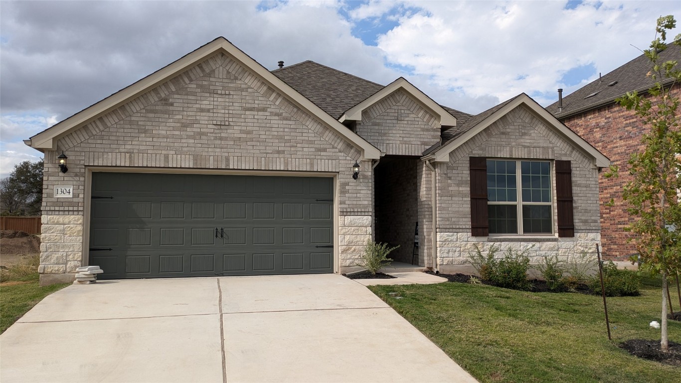 1304 Stonehill Drive Georgetown, TX 78633 - Photo 1 of 1 a front view of a house with a garden and garage