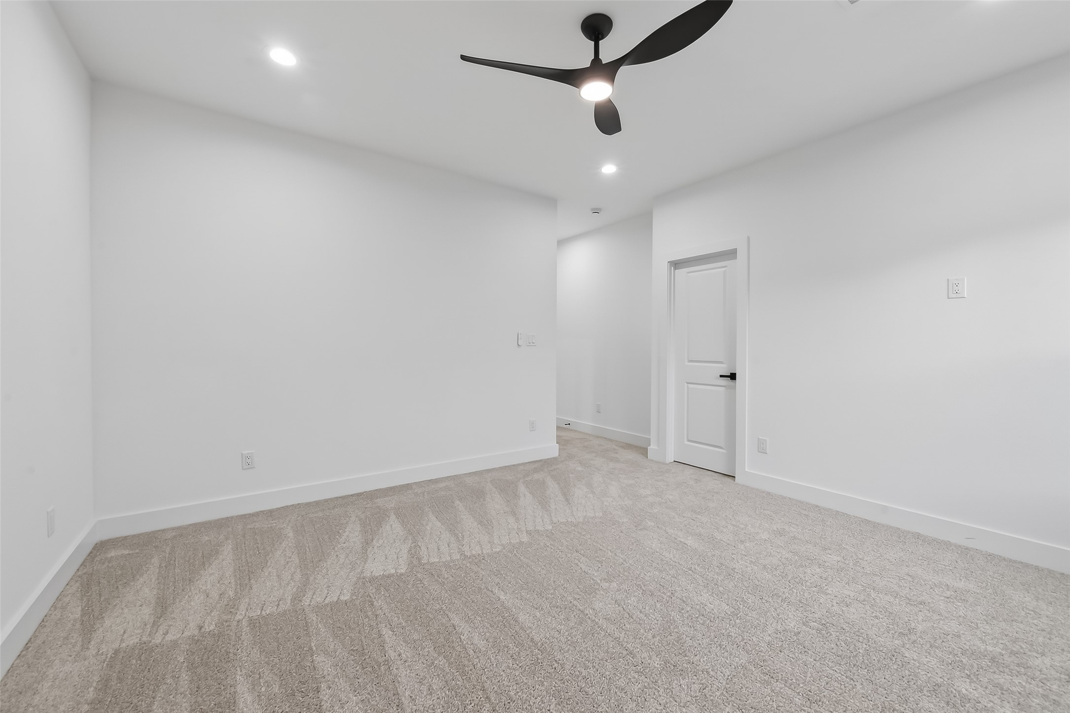 3514 Good Hope Street, Unit B Houston, TX 77021 - Photo 21 of 26 Experience ultimate comfort in this spacious master suite, featuring plush carpeting, modern lighting, and a sleek ceiling fan for a serene retreat.