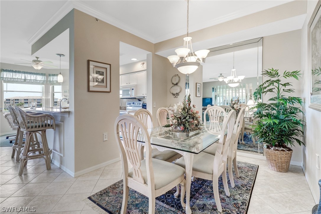14101 Brant Point Circle, Unit 3303 Fort Myers, FL 33919 - Photo 1 of 30 a view of a dining room with furniture and chandelier