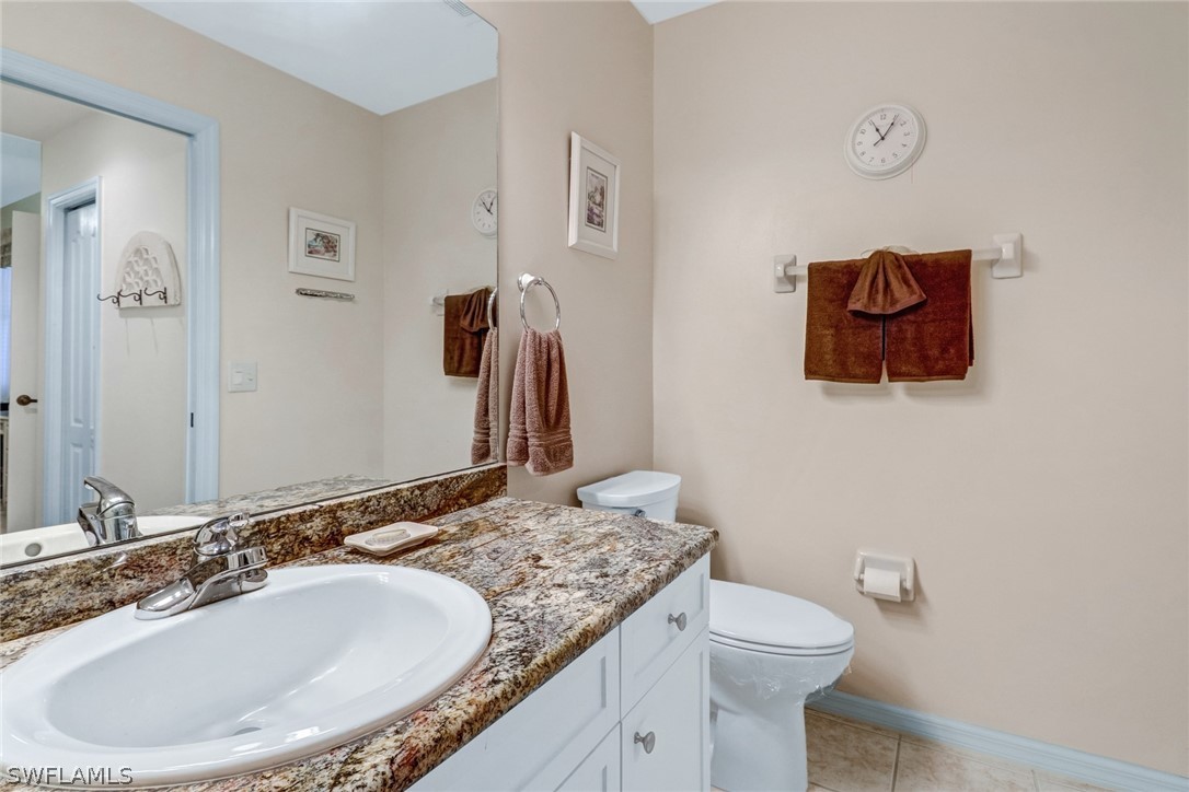 14101 Brant Point Circle, Unit 3303 Fort Myers, FL 33919 - Photo 14 of 30 a bathroom with a granite countertop sink and a mirror