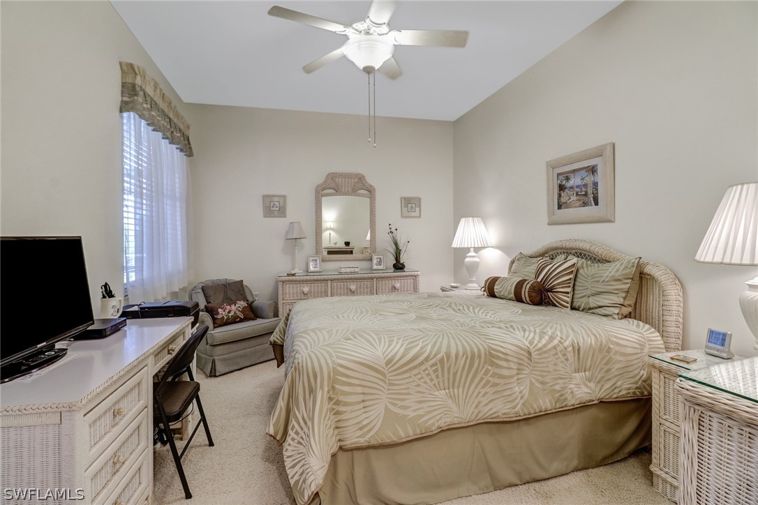 14101 Brant Point Circle, Unit 3303 Fort Myers, FL 33919 - Photo 15 of 30 a bedroom with a bed and a chandelier