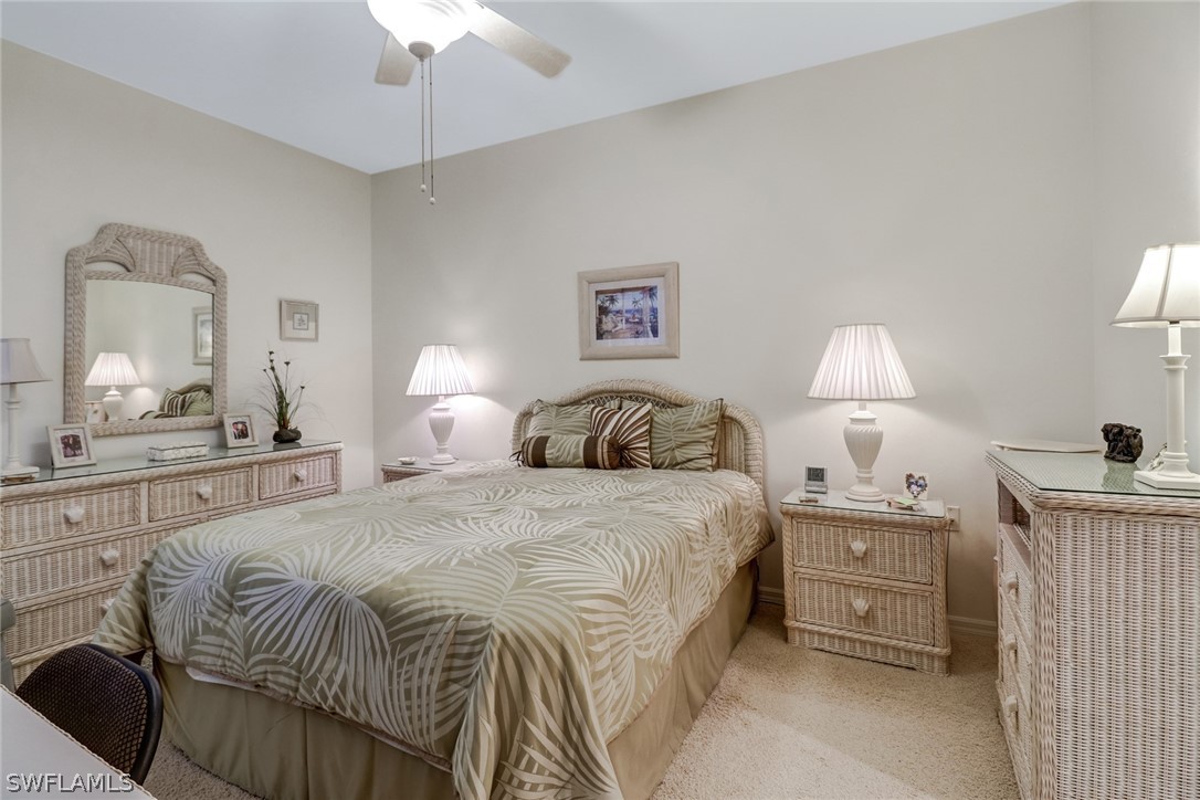 14101 Brant Point Circle, Unit 3303 Fort Myers, FL 33919 - Photo 16 of 30 a bedroom with a bed and a chandelier