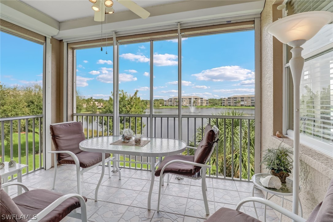 14101 Brant Point Circle, Unit 3303 Fort Myers, FL 33919 - Photo 20 of 30 a living room with furniture and a floor to ceiling window