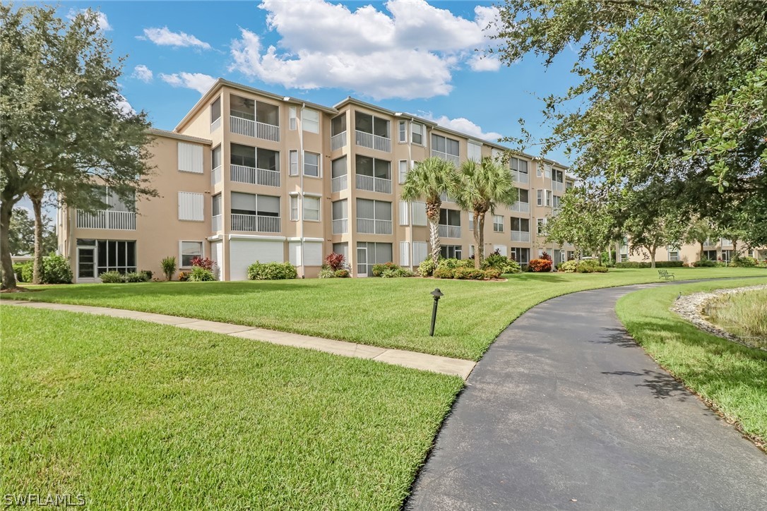 14101 Brant Point Circle, Unit 3303 Fort Myers, FL 33919 - Photo 24 of 30 a view of a building with a yard