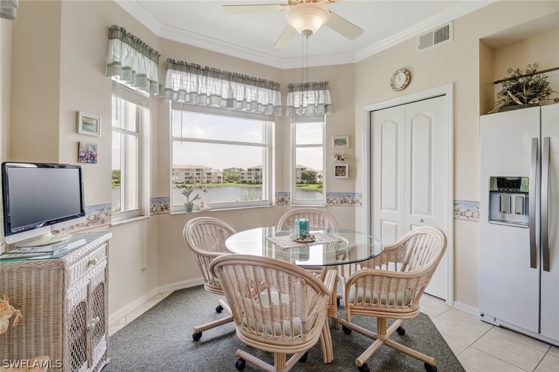 14101 Brant Point Circle, Unit 3303 Fort Myers, FL 33919 - Photo 7 of 30 a dining room with furniture a flat screen tv and a large window