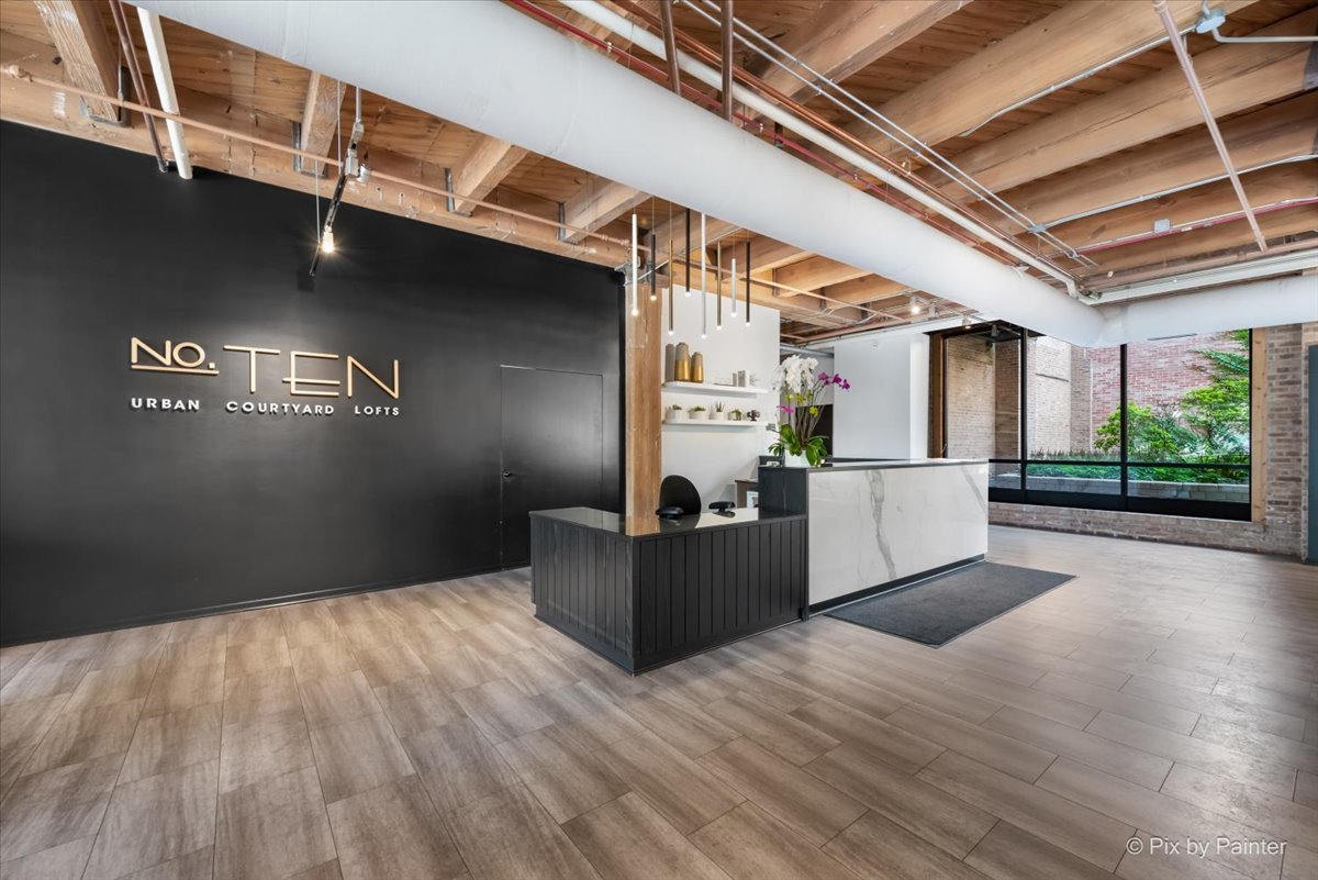 1040 West Adams Street, Unit 459 Chicago, IL 60607 - Photo 17 of 30 a living room with hard wood flooring and furniture