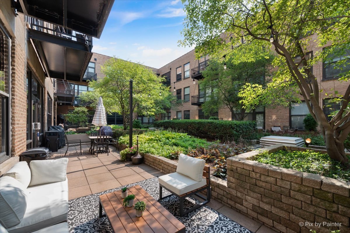 1040 West Adams Street, Unit 459 Chicago, IL 60607 - Photo 24 of 30 a view of a patio with couches table and chairs and potted plants